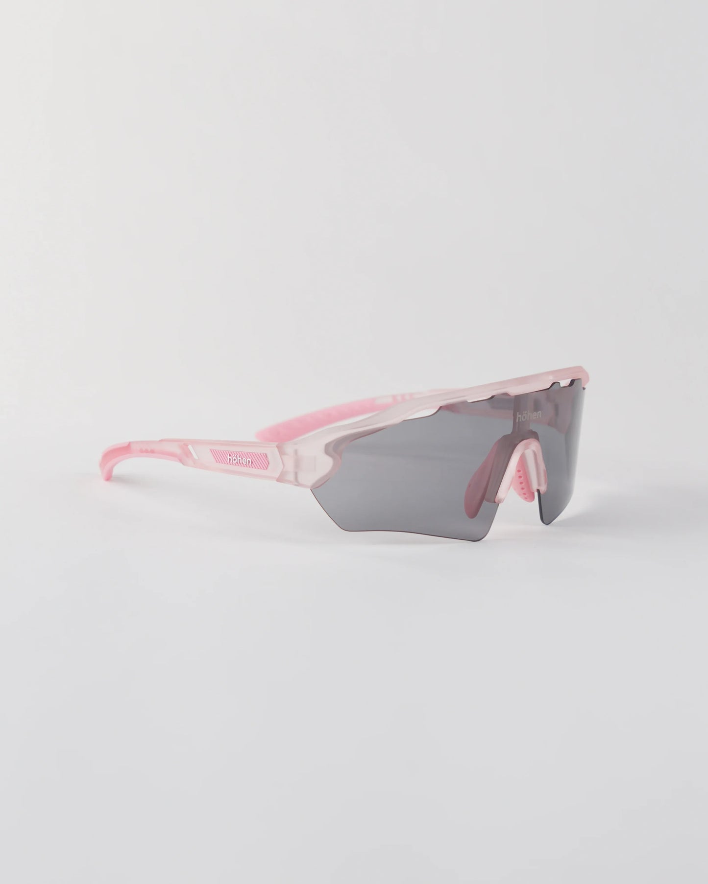 Three-quarter angle of the pink höhen aero sunglasses with a smoke-colored shield lens and ventilated frame top