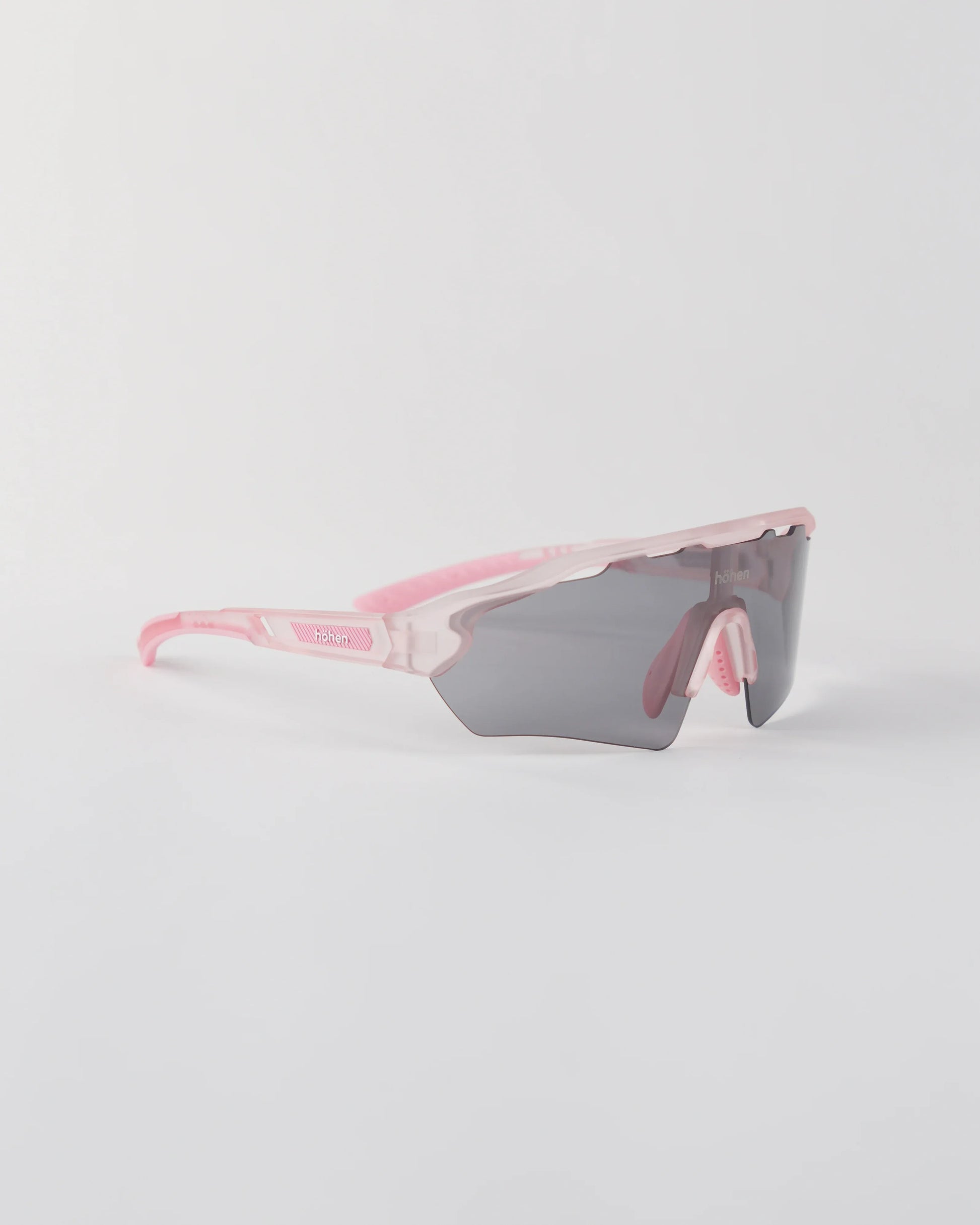 Three-quarter angle of the pink höhen aero sunglasses with a smoke-colored shield lens and ventilated frame top