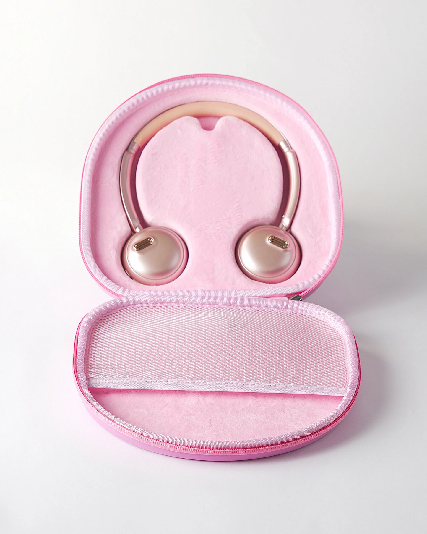 Inside view of the pink höhen aura mini wireless headphones safely stored in their matching pink protective travel case with a mesh pocket