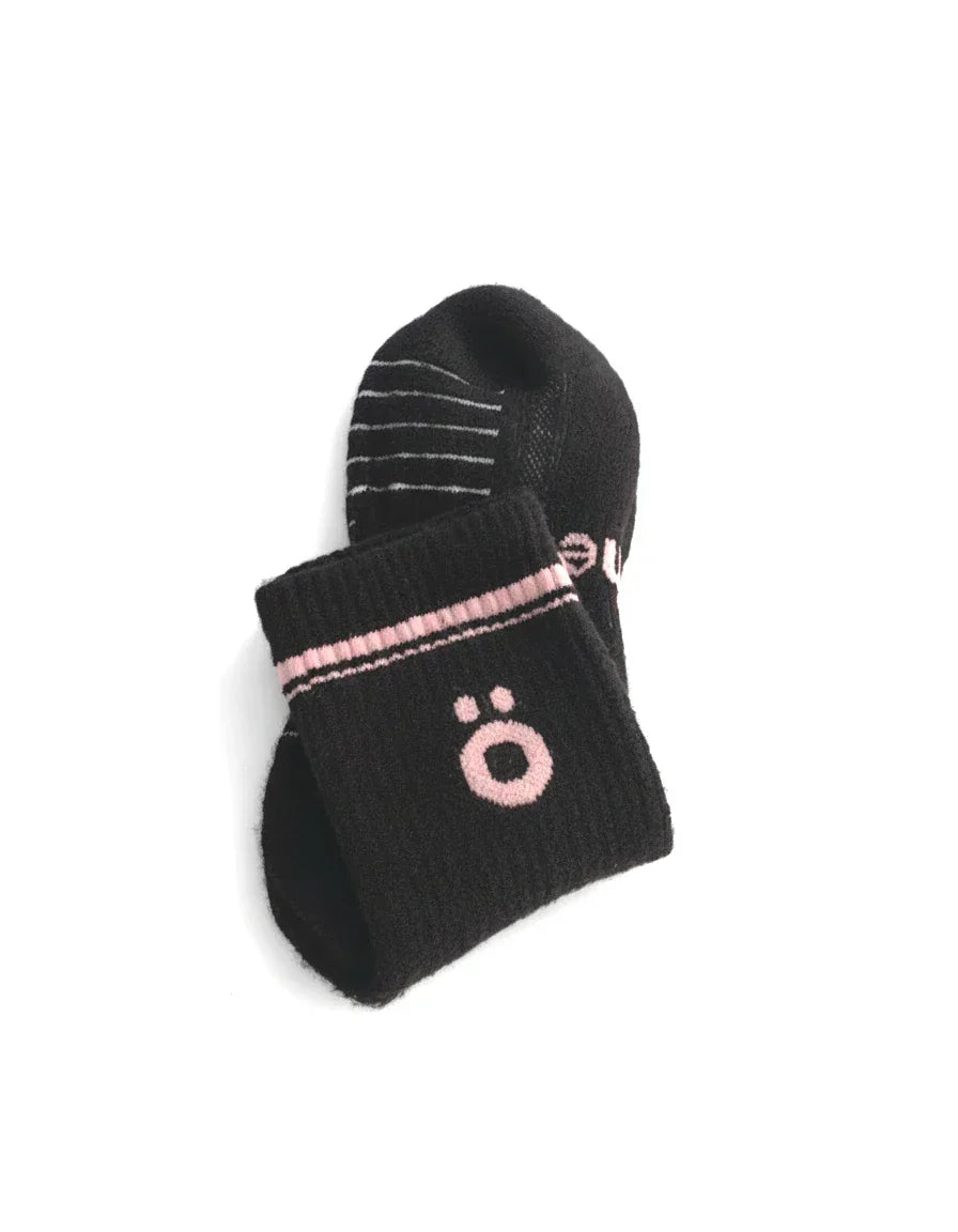 Detail of black höhen merino socks with logo and ribbed finish, soft and durable for active use