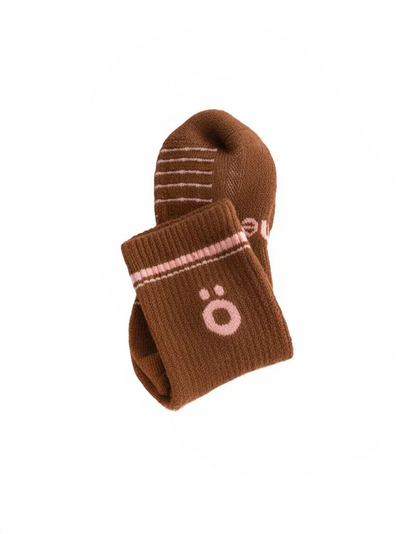 Detail of brown höhen merino socks with logo and ribbed finish, soft and durable for active use