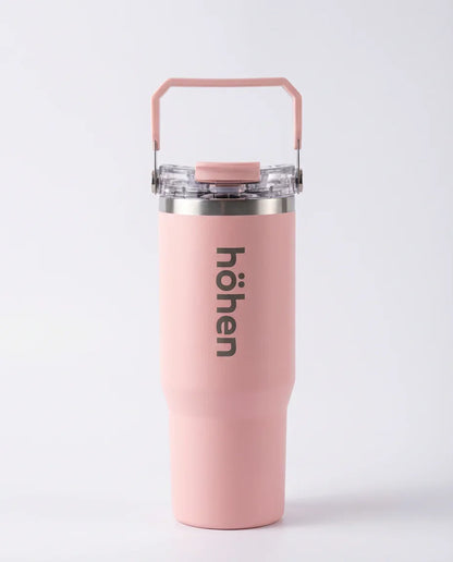 Full view of the pink höhen Essential Tumbler featuring a built-in carry handle and clear lid.