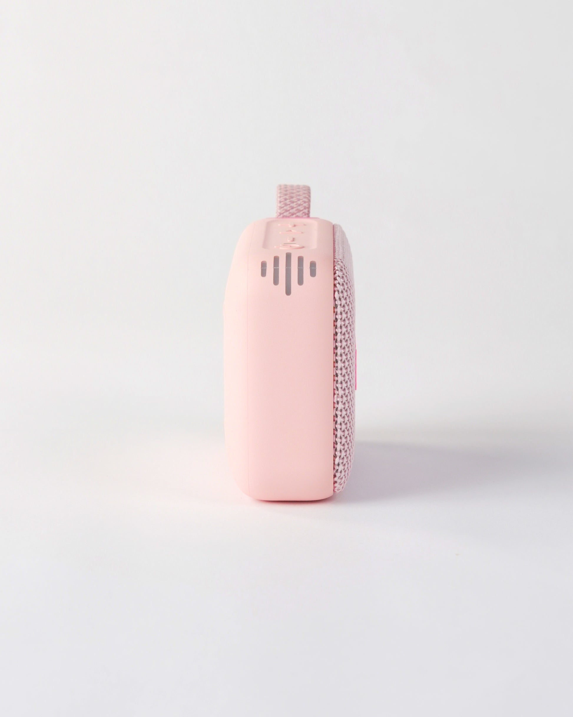 Side profile of the höhen move speaker in pink, showing the smooth matte finish and side sound ventilation slots