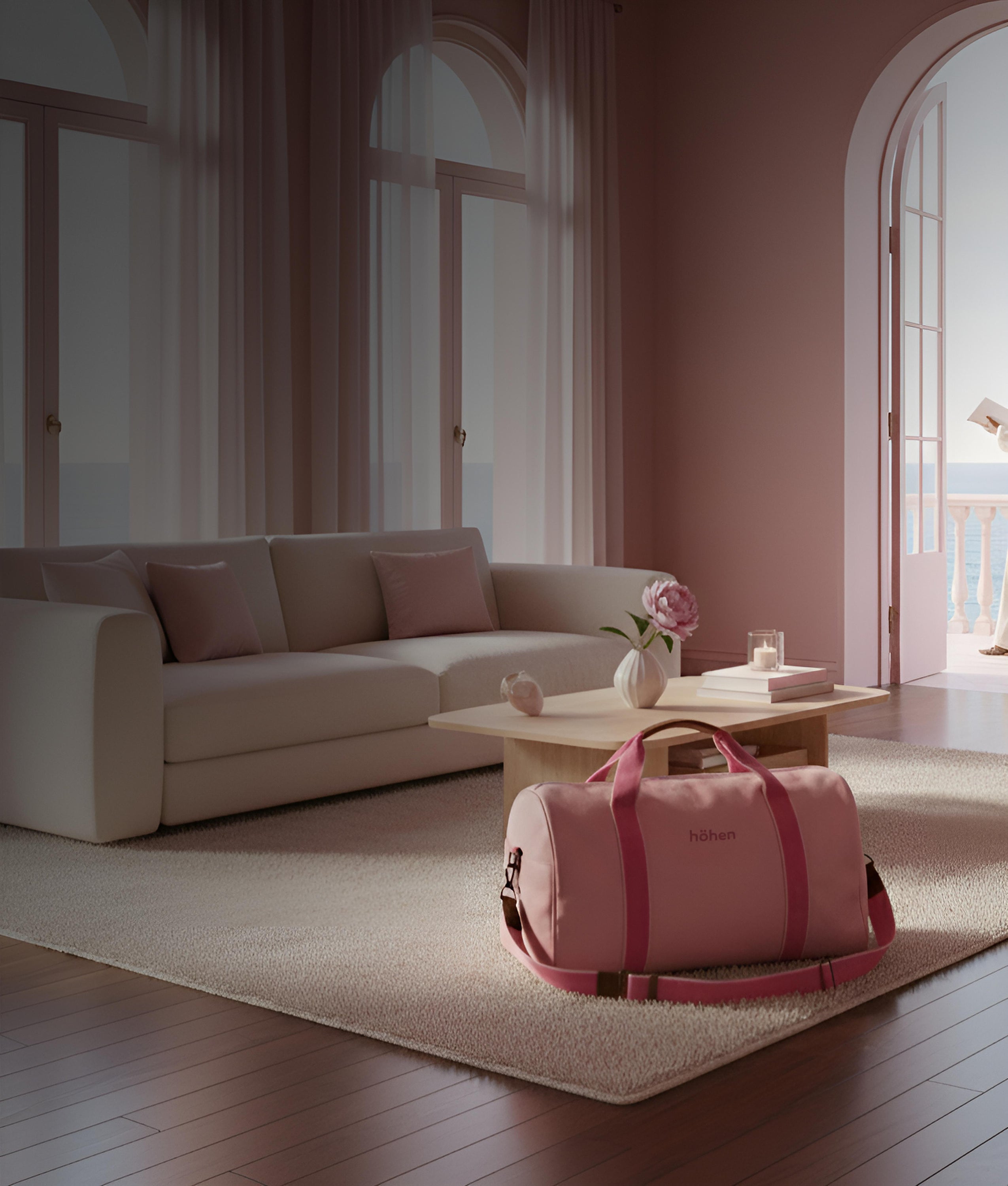 The höhen one travel bag in pink placed in a minimalist living room, ideal for weekend getaways.