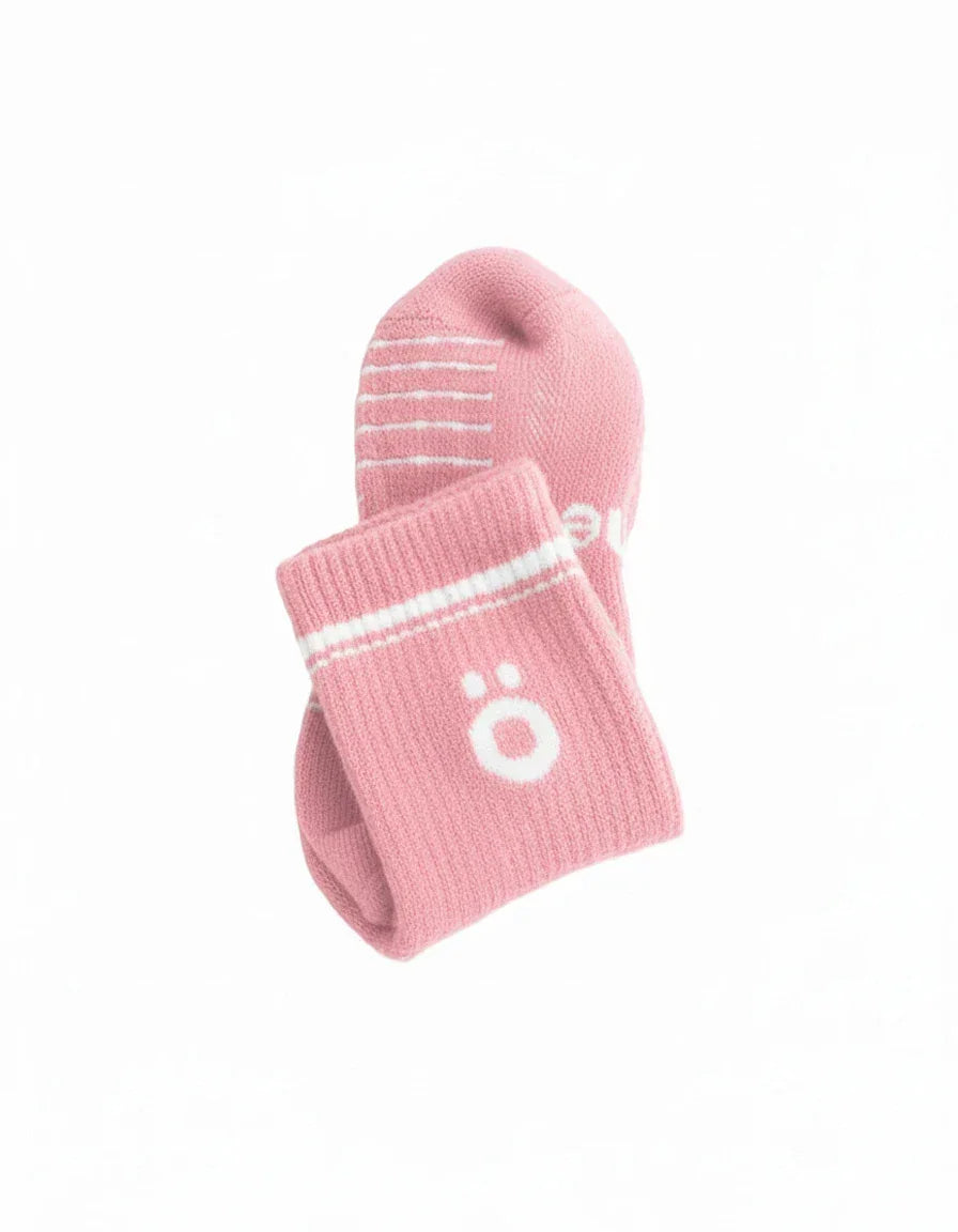 Detail of pink höhen merino socks with logo and ribbed finish, soft and durable for active use