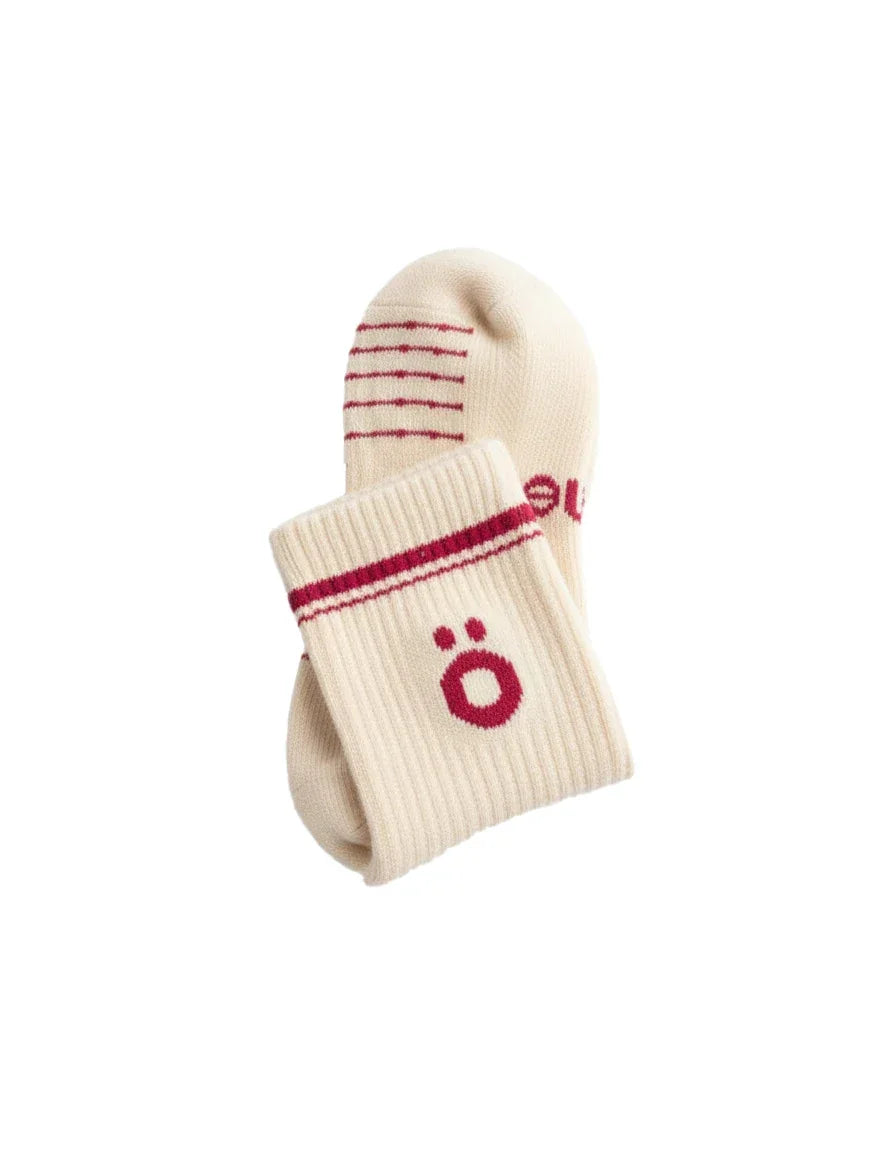 Detail of white höhen merino socks with logo and ribbed finish, soft and durable for active use