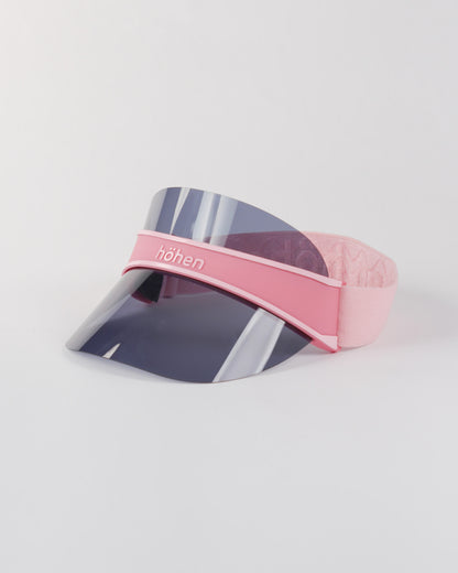 Side view of a pink höhen soleil women’s sports visor with a dark transparent shield and adjustable elastic band on a white background.